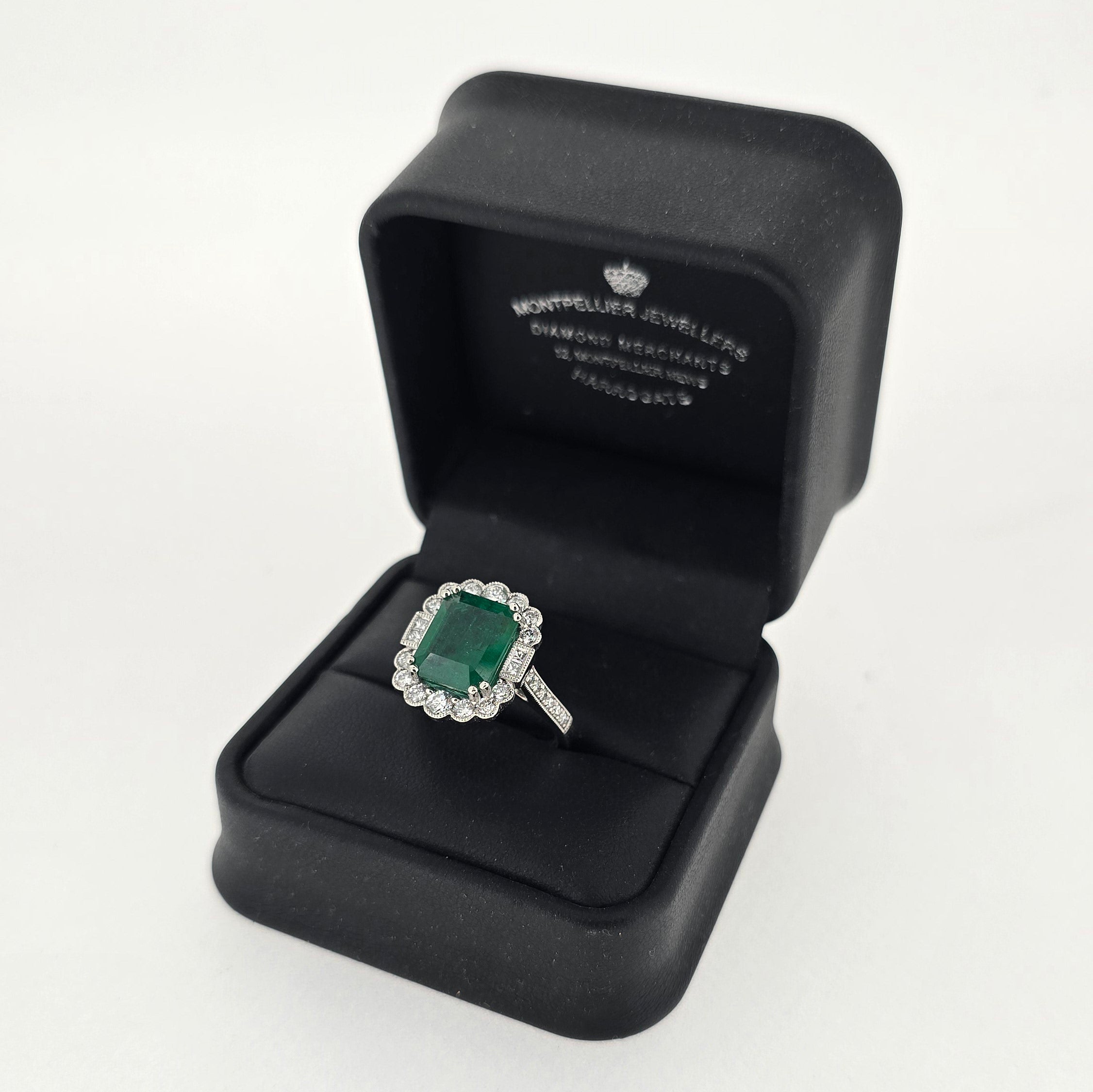 3.86ct Emerald and Diamond Cluster Ring with Diamond Shoulders Set in Platinum - Montpellier Jewellers