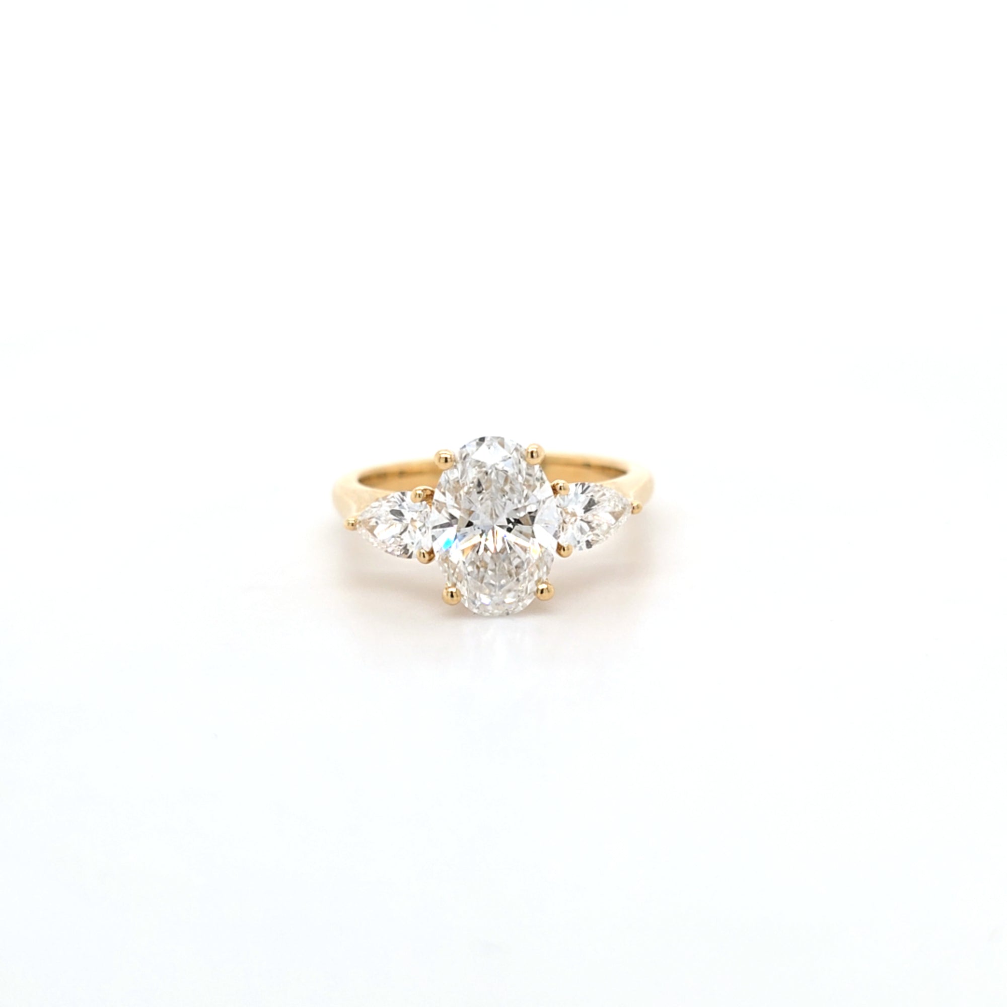 2.02ct D/VS2 Oval Cut LAB Diamond Ring with Pear Shape Side Stones Set in 18ct Yellow Gold