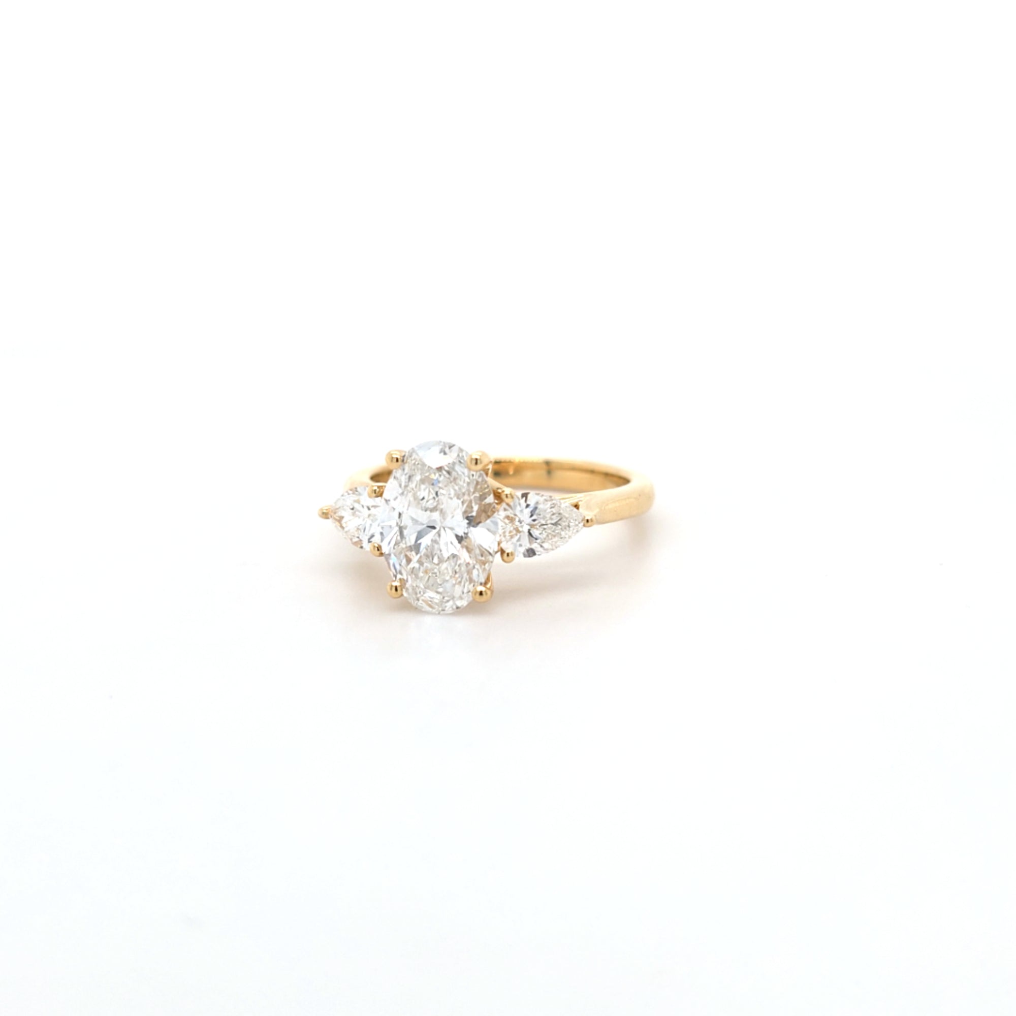 2.02ct D/VS2 Oval Cut LAB Diamond Ring with Pear Shape Side Stones Set in 18ct Yellow Gold