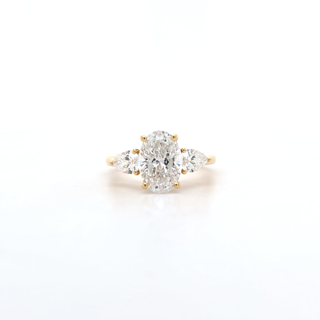 2.02ct D/VS2 Oval Cut LAB Diamond Ring with Pear Shape Side Stones Set in 18ct Yellow Gold
