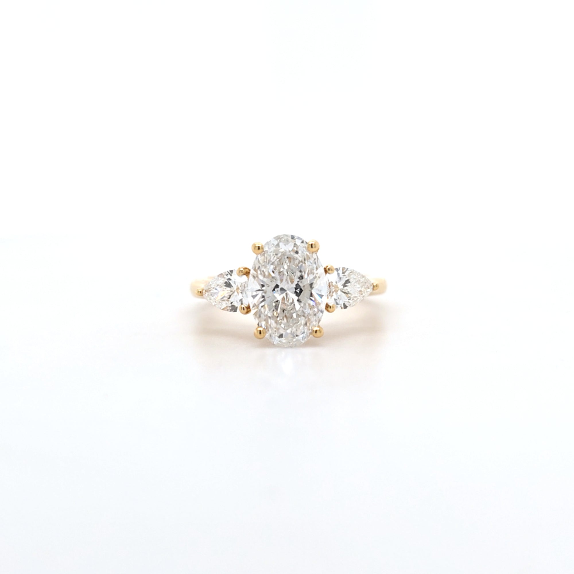 2.02ct D/VS2 Oval Cut LAB Diamond Ring with Pear Shape Side Stones Set in 18ct Yellow Gold